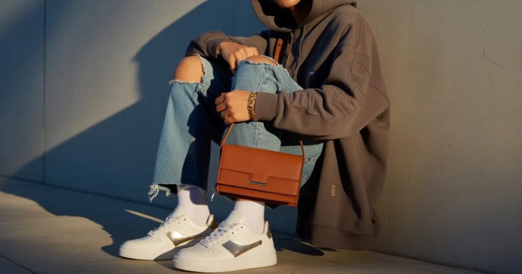 Luxury Streetwear outfit featuring premium oversized hoodie and tailored joggers styled in an urban setting